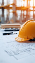 construction safety helmet and blueprint with tools on table in foreground, construction site in background with sun flare.