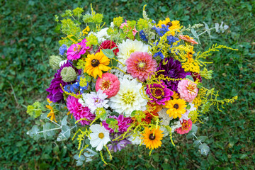 Summer bouquet. Beautiful multi colored fresh flower arrangement. Birthday weddding bouquet made of summer flowers photographed outdoors.