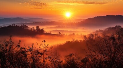 Obraz premium Misty Sunrise Over Silhouetted Mountains