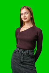 Young Woman In Maroon Sweater And Denim Skirt Posing In Front Of A Green Screen