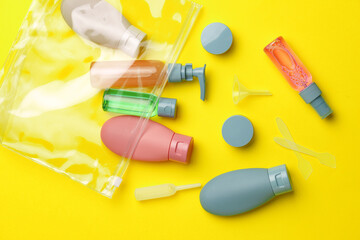 Travel Size Bottles And Containers in a bag On A Yellow Background