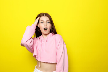 Young Female Model Posing In Pink Clothes On Bright Yellow Background Astonishment