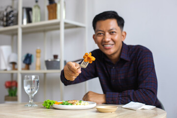 Asian Man Wear Casual With Braces Showing Sausage While Lunch At Home