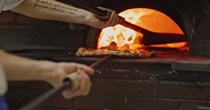 Removing authentic neapolitan pizza from wood-fired oven