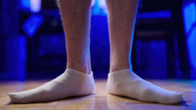 Flat feet with relaxed arch in white socks