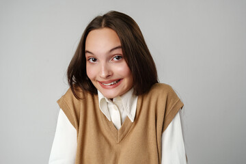 Photo of young shy adorable lady hold hands against gray background