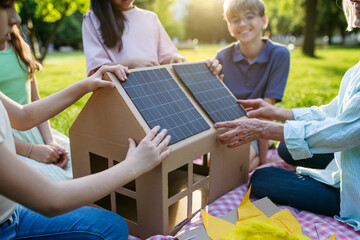 Children learning about renewable energy and solar panels during sustainable education class...