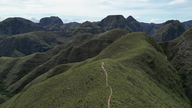 Codo de los Andes Bolivia aerial rises over narrow mountain ridge path