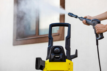 Washing Facade House Cleaning Windows Outside. High Pressure Washer for Cleaning House Facade and...