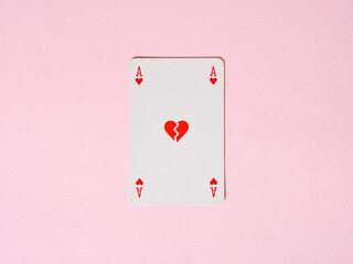 Ace of hearts playing card showing broken heart on pink background