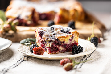 Fresh and hot blackberry cake made of blackberries, flour and eggs. Vegan fruit sponge cake