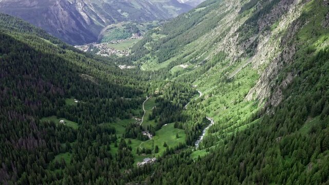 Scenic aerial view of lush green valleys and mountains near Cascate del Rutor waterfall