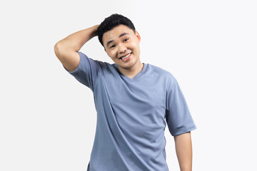 Portrait of smile happy man looking camera with pleased expression  and holding his hand behind the back of his head stand against white background