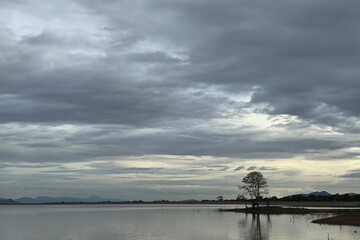 Obraz premium Dramatic sky battles dark water as angry clouds unleash nature's fury