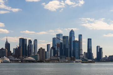 Naklejka premium Manhattan skyline with modern skyscrapers and waterfront seen from Hudson River.