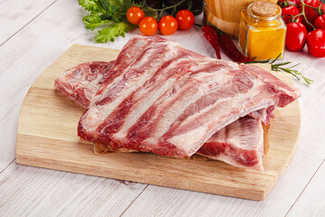 Raw pork ribs over board
