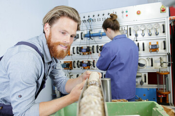 young worker in warehouse with clipboard checking inventory