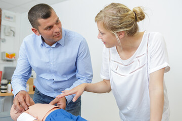 cpr training on baby dummy indoors
