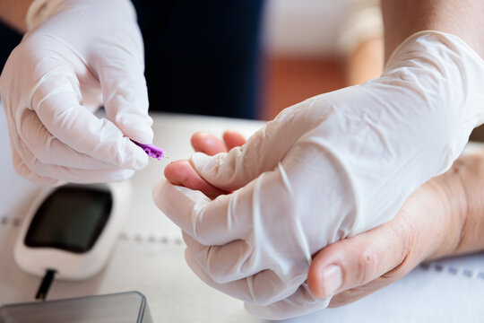 Medical Professional Testing Blood Glucose for Hypoglycemia