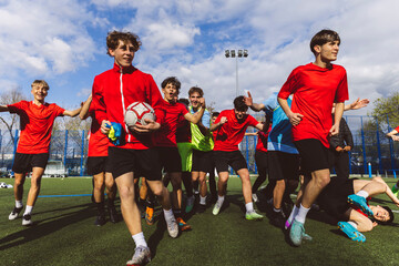 Happy soccer players running together on field