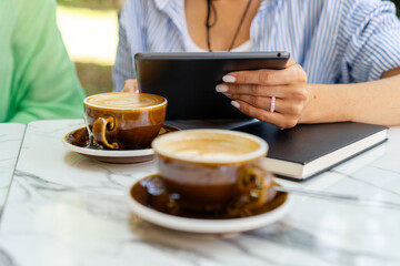 Business woman using tablet at coffee table