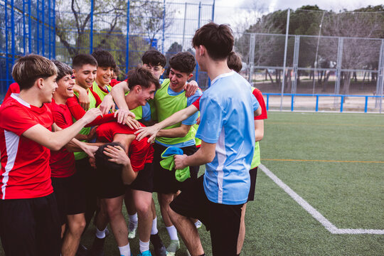 Happy soccer players having fun on field