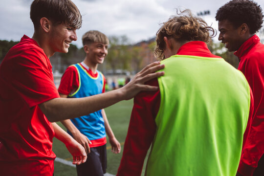 Happy soccer players having training at field