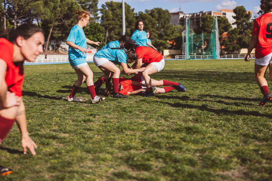 Athletes playing rugby on sports field