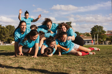 Happy rugby players in scrum on field