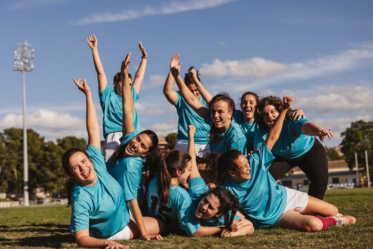 Happy rugby players in scrum winning match on field