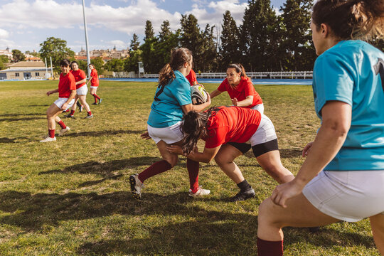 Rugby team in scrum on sunny day at field