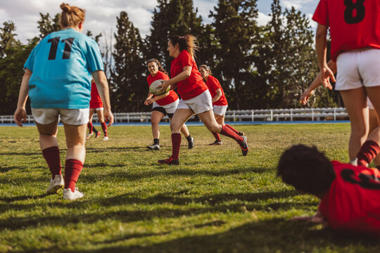 Rugby teams playing match on sunny day at sports field