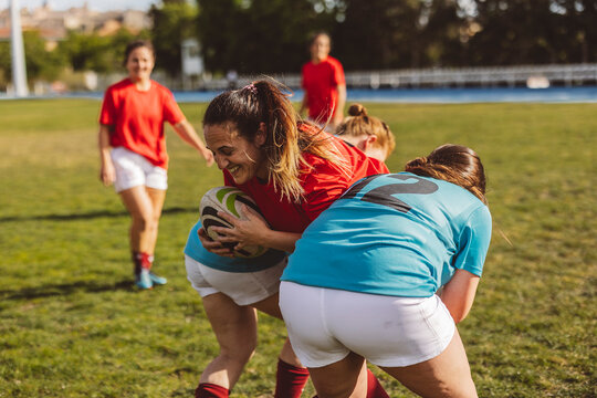 Happy rugby teams in scrum on sunny day
