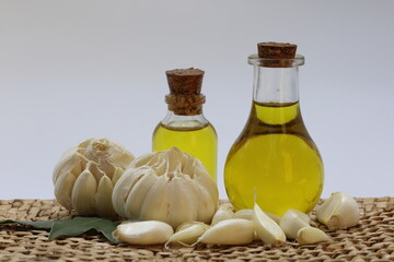 olive oil and garlic on white background	
