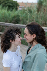 Fototapeta premium Lesbian couple interacting on bridge in daytime