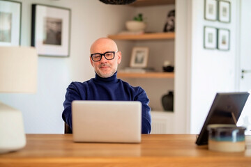 Man sitting at home and using his laptop for work