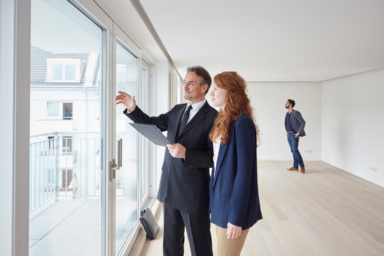 Young woman talking to businessman in new apartment
