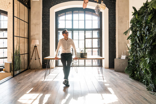 Thoughtful mature businessman leaning on desk