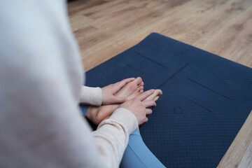 Yoga practitioner seated on mat in meditation pose
