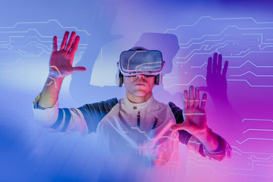 Man wearing virtual reality simulators gesturing and touching transparent screen