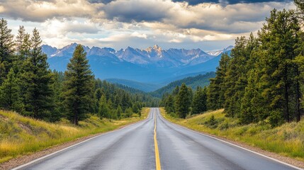 Scenic Mountain Road Leading to Majestic Snow-Capped Peaks Under a Dramatic Sky with Lush Green Forests on Both Sides