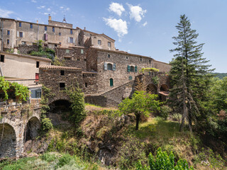 Obraz premium Summer landscape view of ancient St Martial village and church in the Cévennes National Park, UNESCO World Heritage site, Gard, France