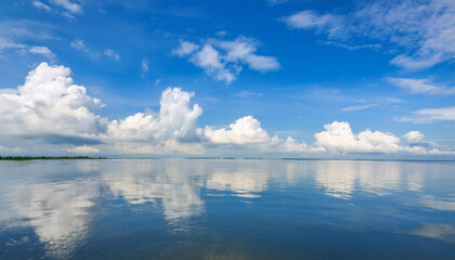 Obraz premium Blue Sky and Clouds Reflecting in Water and Copy Space