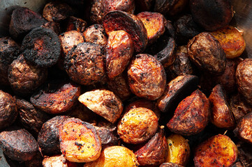 potatoes fried with a crust in a pan. appetizing ruddy baked potatoes
