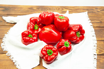 red bell pepper on a white towel on the table. Bulgarian juicy pepper on a light texture