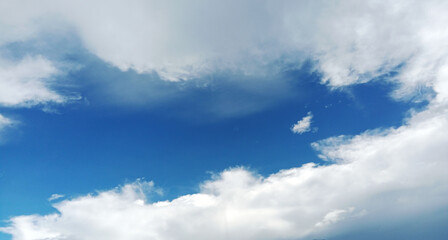 A beautiful sky when the blue color is in the center and the outer part is white clouds.
