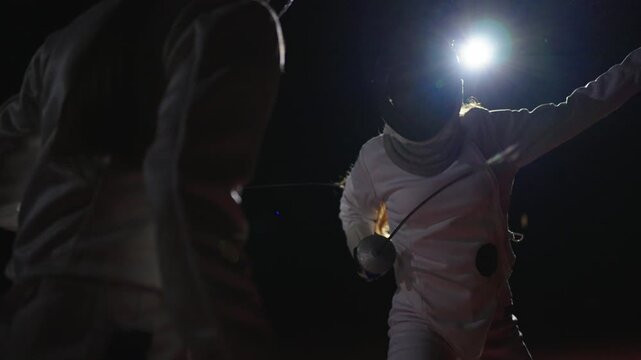 Two Women Rapier Players Fighting In Darkness, Portrait Against Bright Soffit, Brave Swordswoman