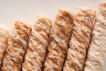 Crispy and delicious coconut crispy egg roll snack close up on white background
