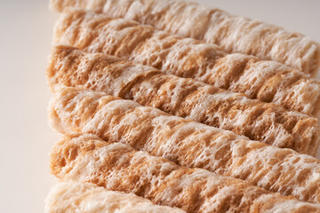 Crispy and delicious coconut crispy egg roll snack close up on white background