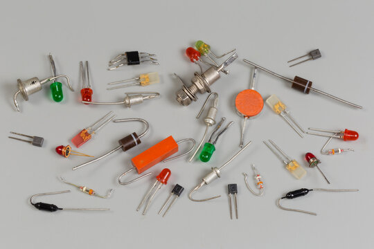 Different old semiconductor diodes in various packages on gray surface